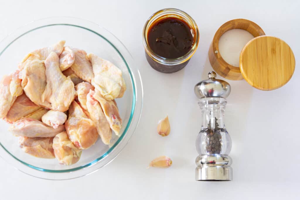 Ingredients for Easy BBQ Wings, including chicken wings, salt, pepper, garlic, and BBQ sauce.