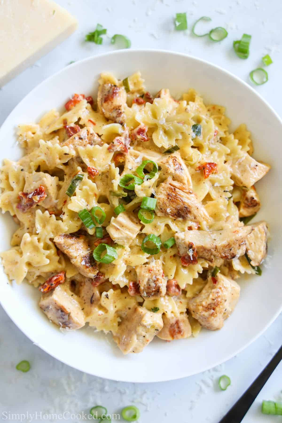 Plate of Blackened Chicken Alfredo garnished with green onion.