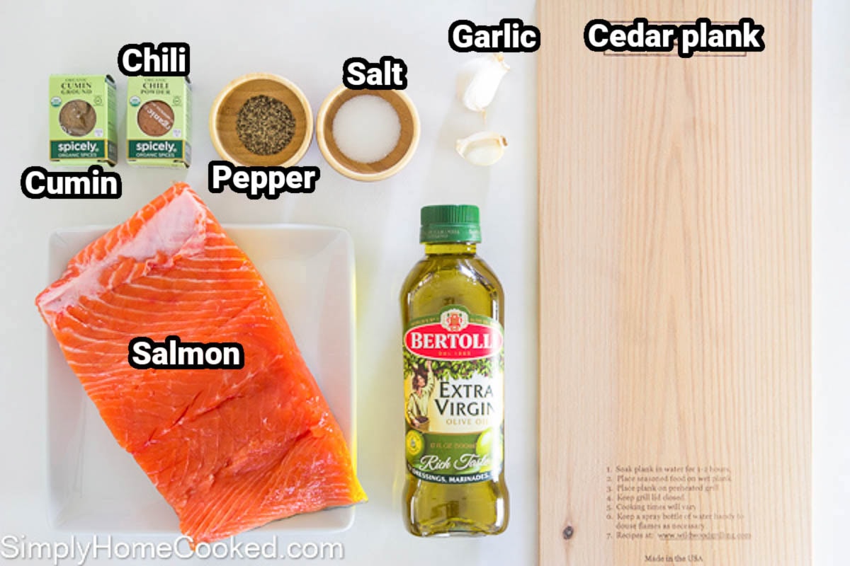 Ingredients for Cedar Plank Salmon: salmon, olive oil, cedar plank, garlic, salt, pepper, cumin, and chili powder.