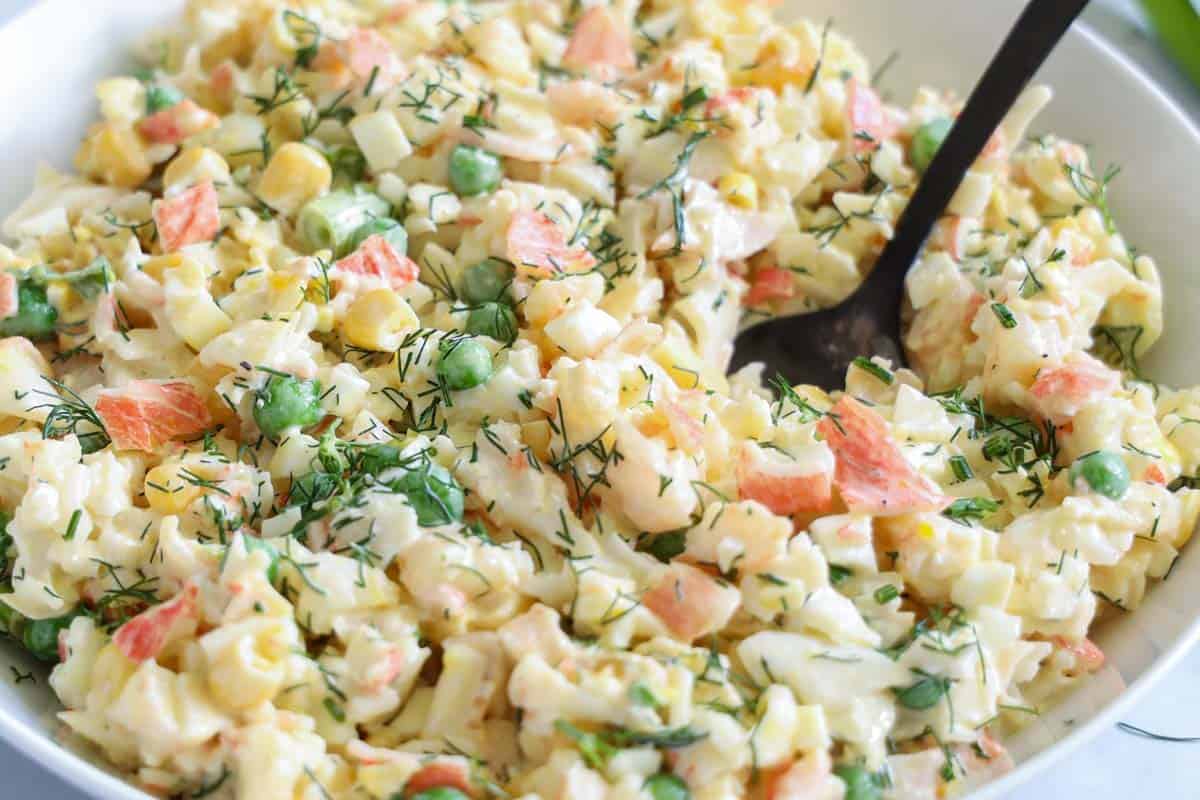 Horizontal image of Crab Salad in a bowl with a spoon