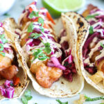 square image of fish tacos with toppings