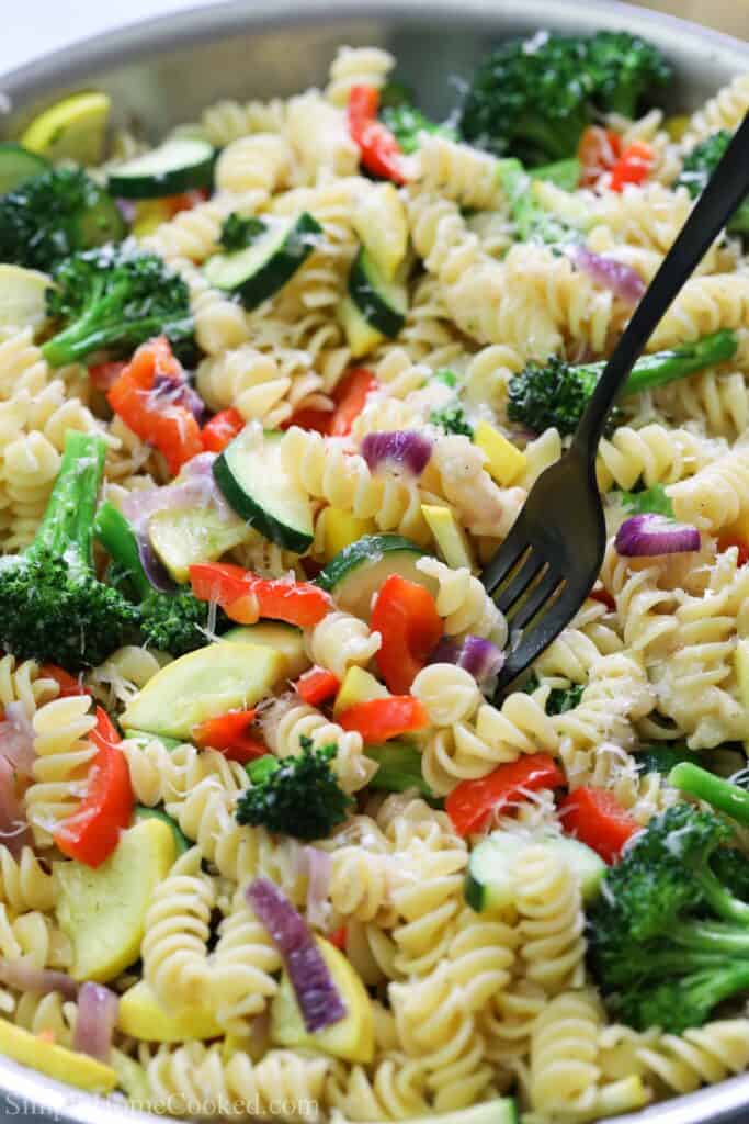 Vertical image of a fork in Pasta Primavera