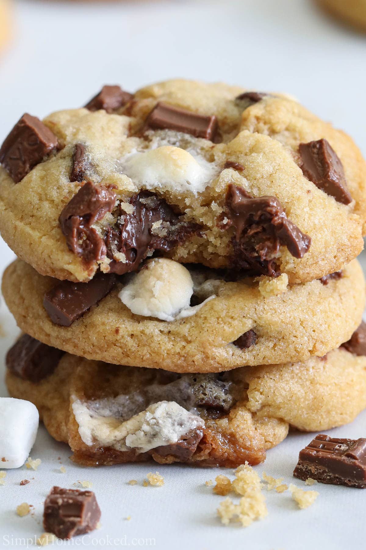 Verical image of S'mores Cookies stacked with a bite missing