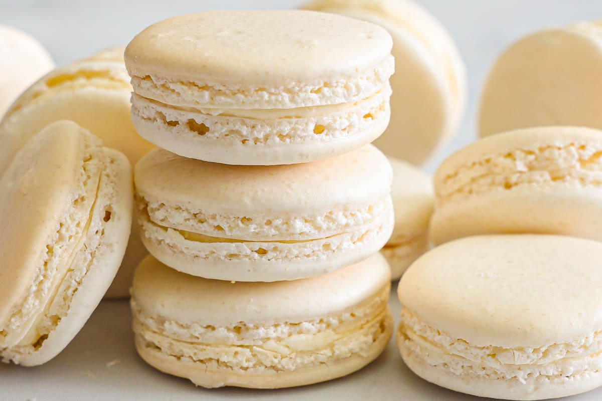 Horizontal image of stack of Vanilla Macarons and more nearby