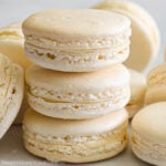 Square image of stack of Vanilla Macarons and more nearby