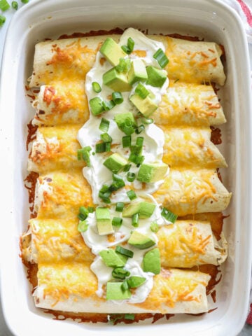 Vertical image of Easy Chicken Enchiladas with sour cream and chive on top
