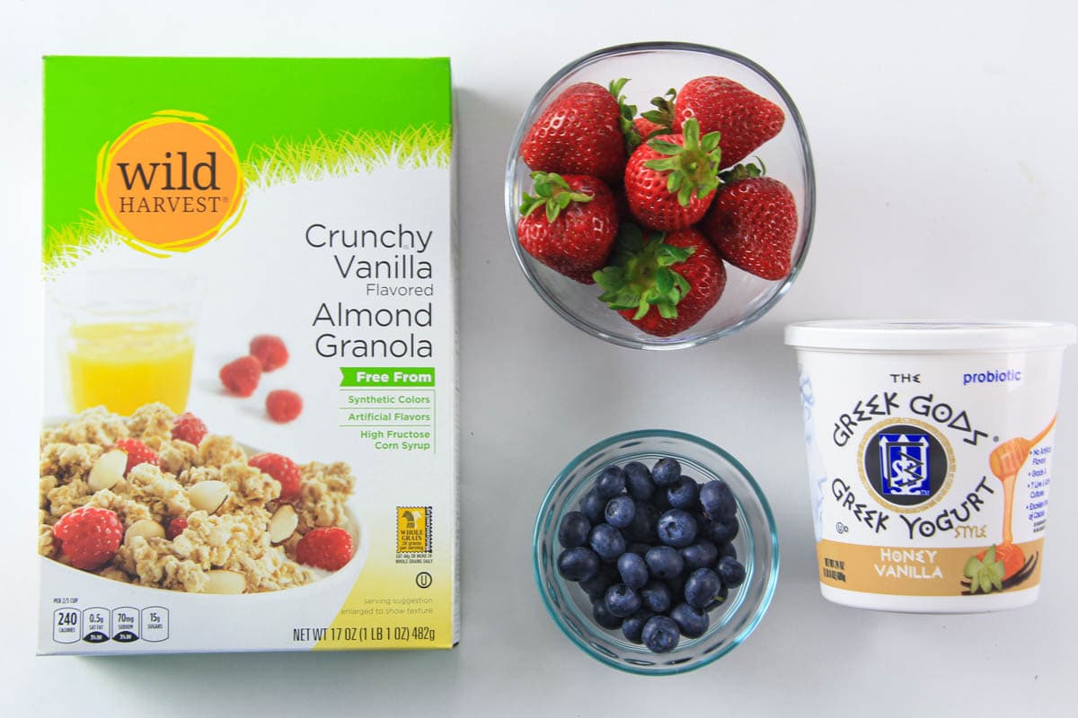 Ingredients for Yogurt Parfait, including granola, strawberries, blueberries, and yogurt.