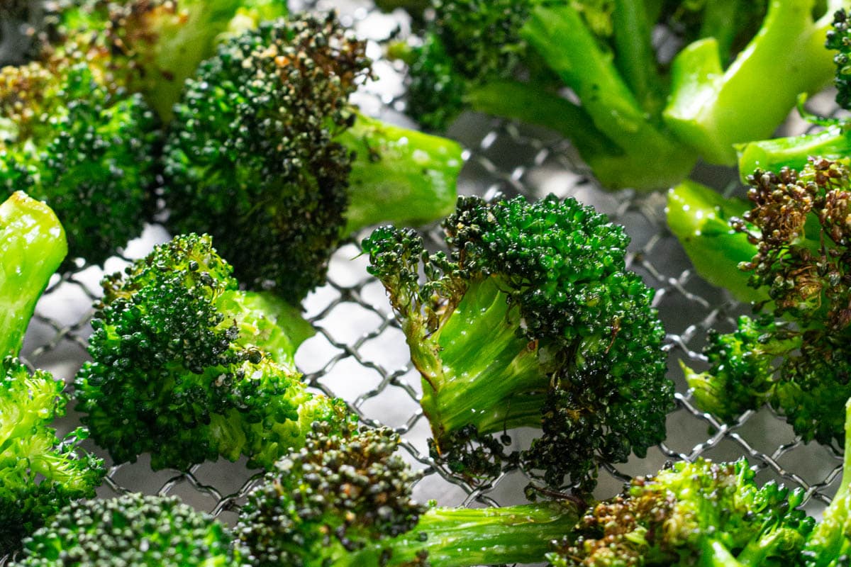 Horizontal image of Crispy Air Fryer Broccoli on a cooling rack.