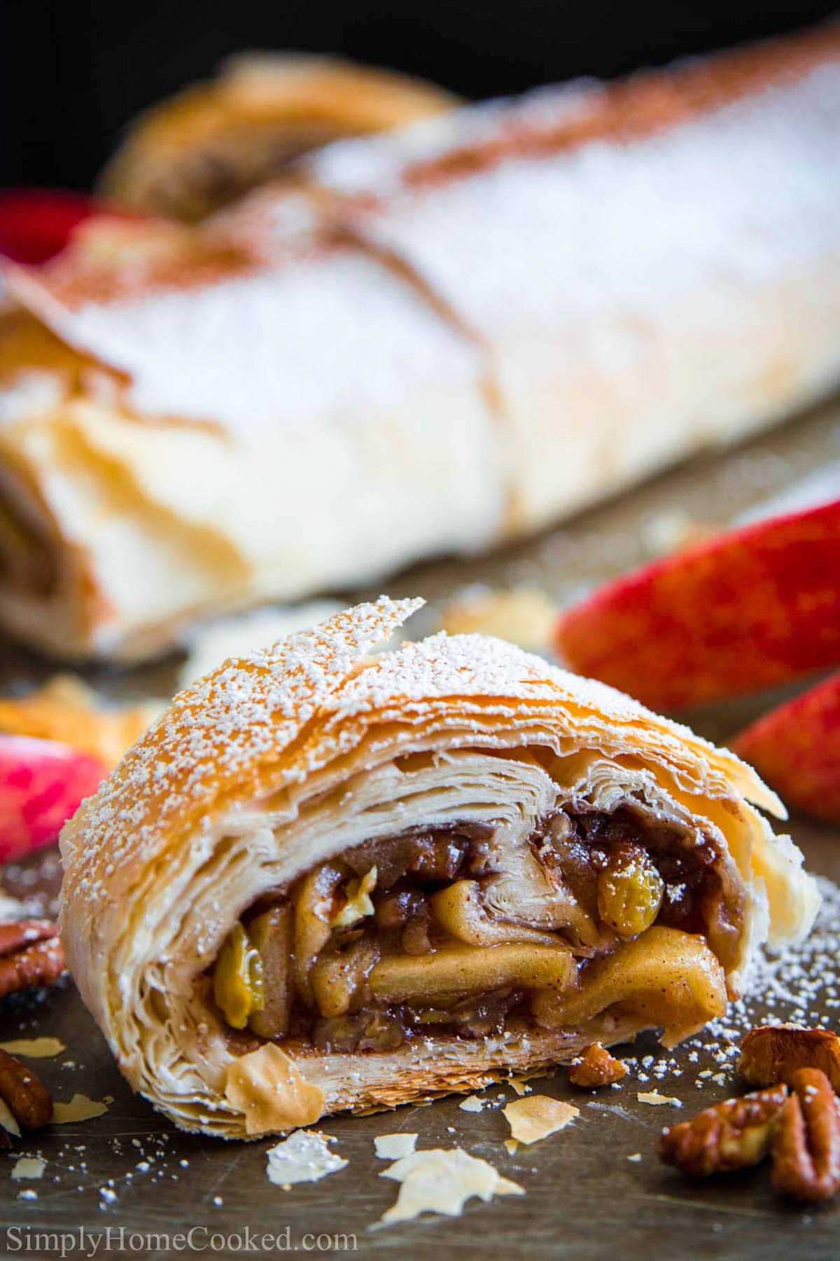 close up image of a sliced piece of homemade apple strudel. 