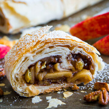 Square image of Apple Strudel cut in half, and another in the background.