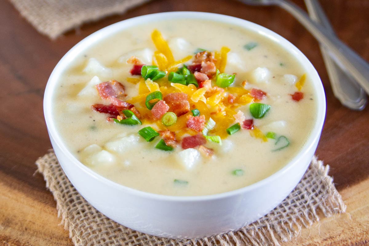 Horizontal image of Baked Potato Soup with toppings in a bowl