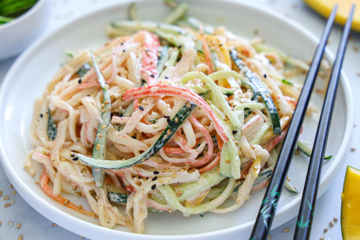 Horizontal image of Kani Salad on a plate with chopsticks