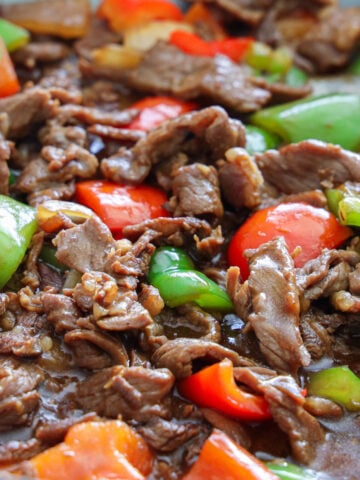 close up image of pepper steak with sauce over the top
