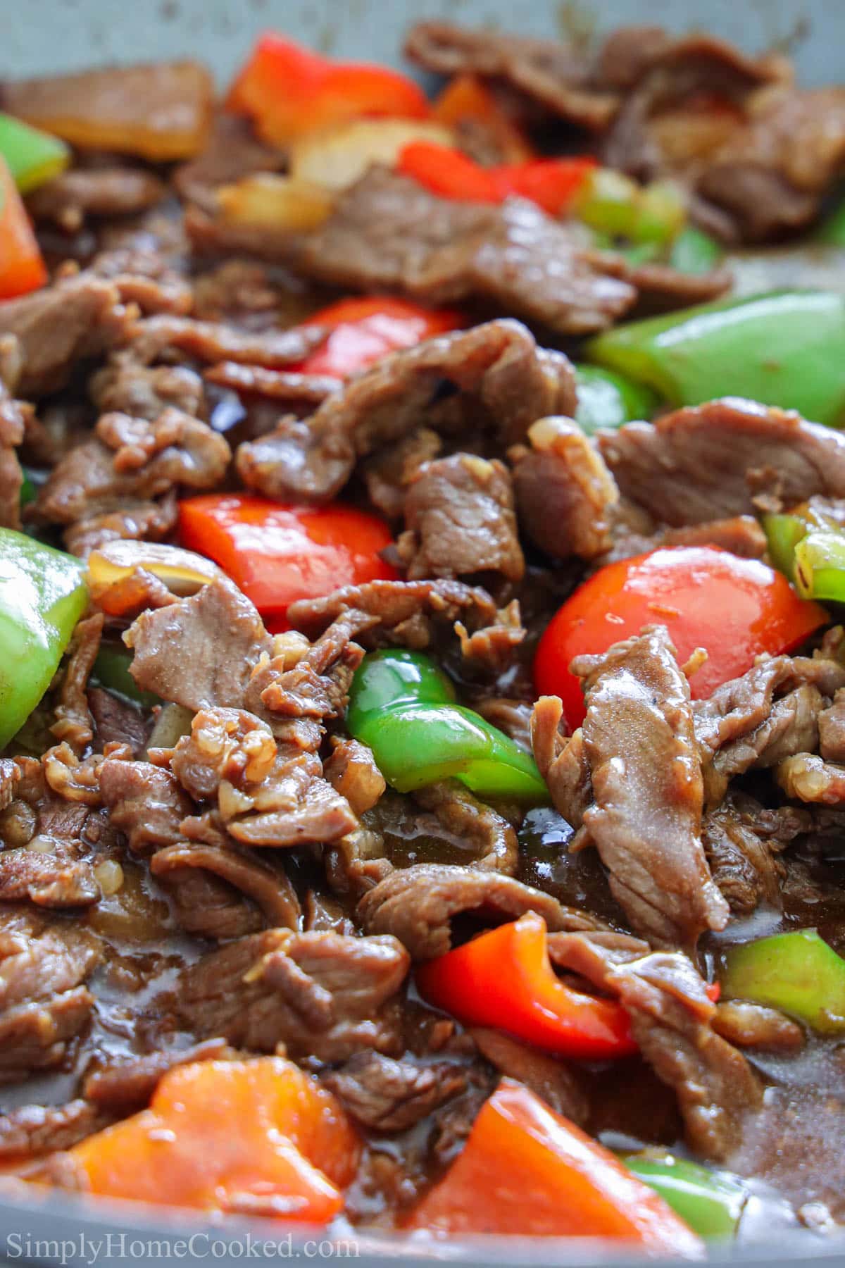 close up image of pepper steak with sauce over the top