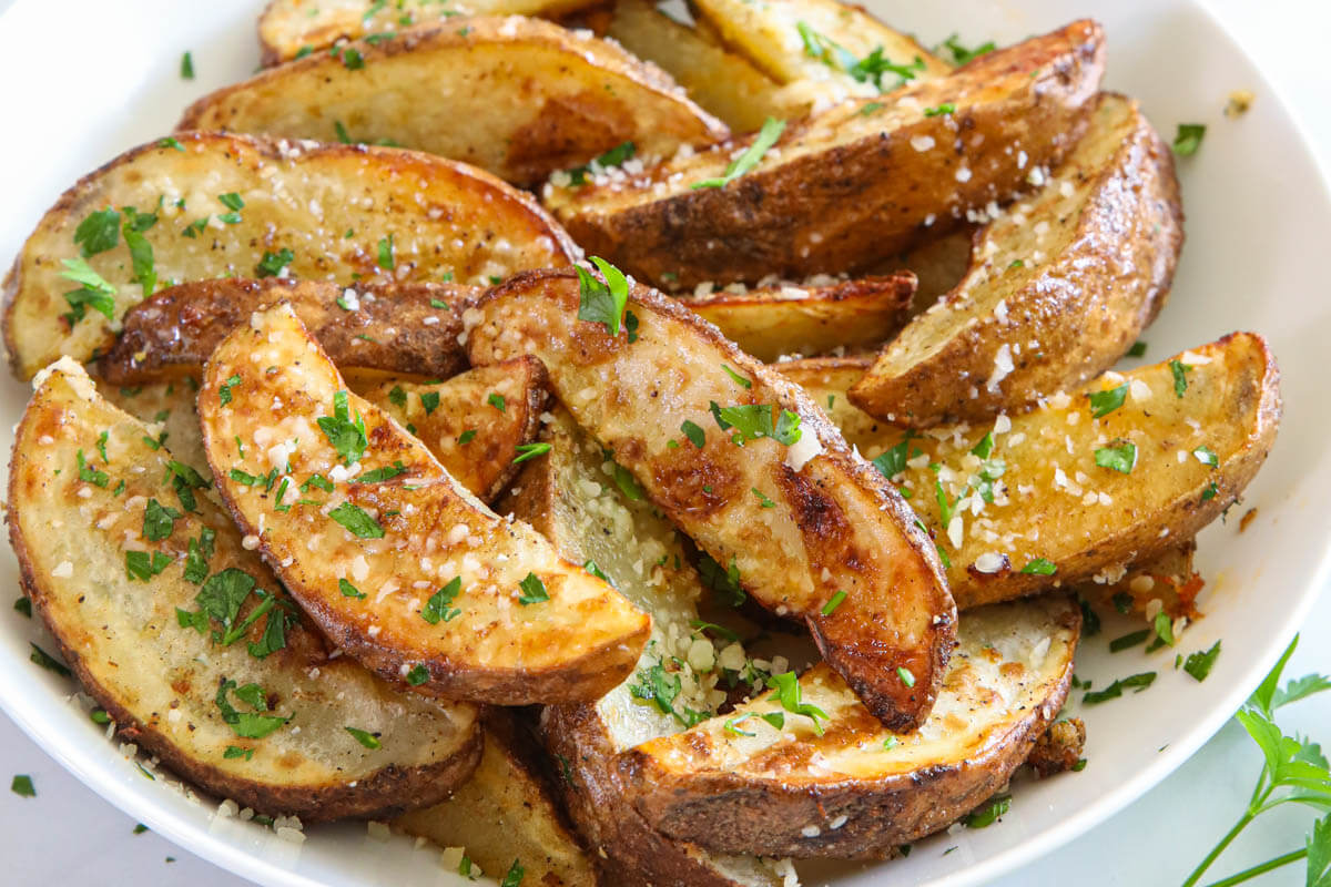 Horizontal mage of Air Fryer Potato Wedges in a white dish