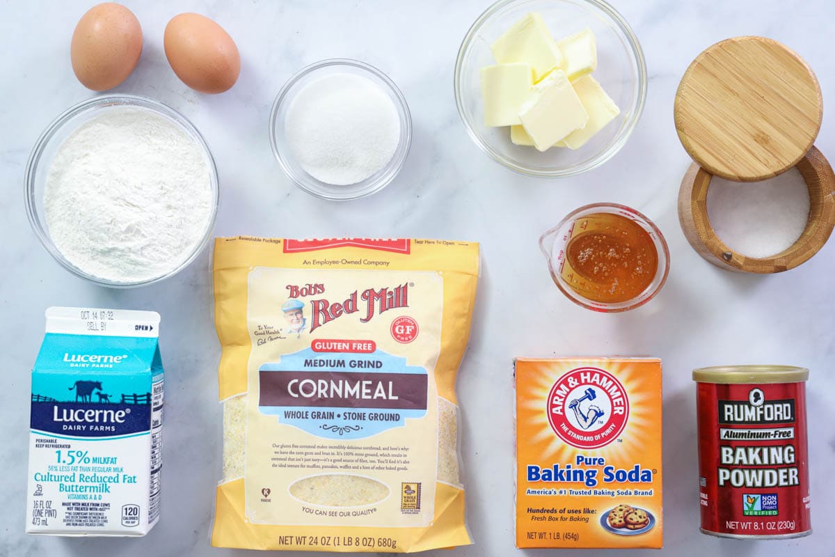 Ingredients for Cornbread Muffins, including flour, salt, baking soda, cornmeal, baking powder, buttermilk, eggs, sugar, honey, and butter.