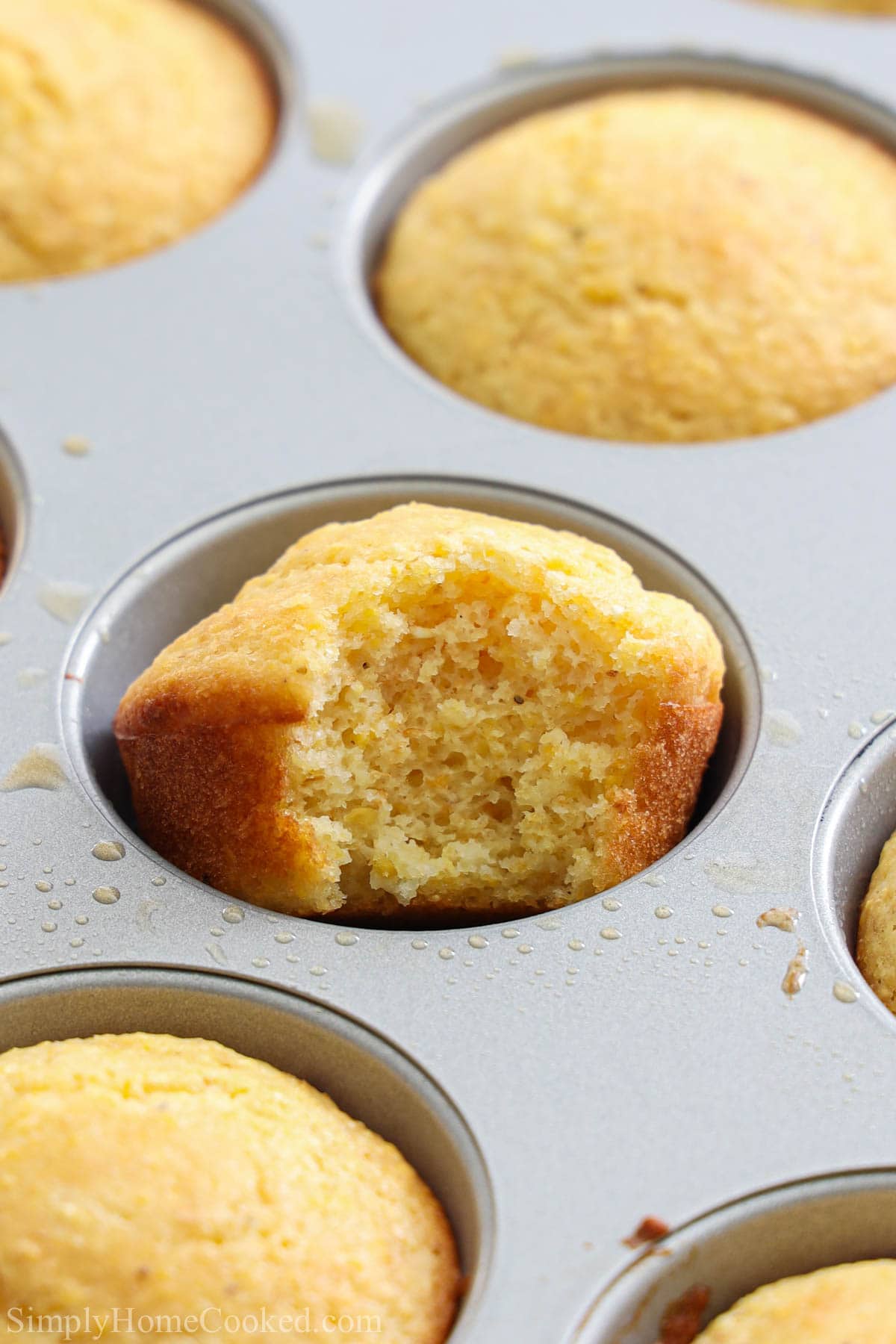 Vertical close up image of Cornbread Muffins in a muffin tin