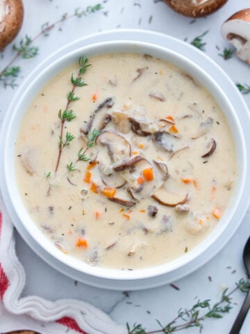 Vertical image of Cream of Mushroom Soup in a white bowl