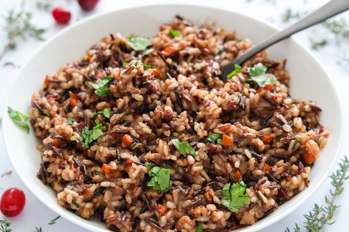 Horizontal image of a bowl of Wild Rice with a spoon.