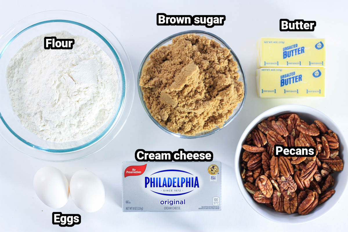 Ingredients for Pecan Tassies, including flour, brown sugar, butter, cream cheese, eggs, and pecans.