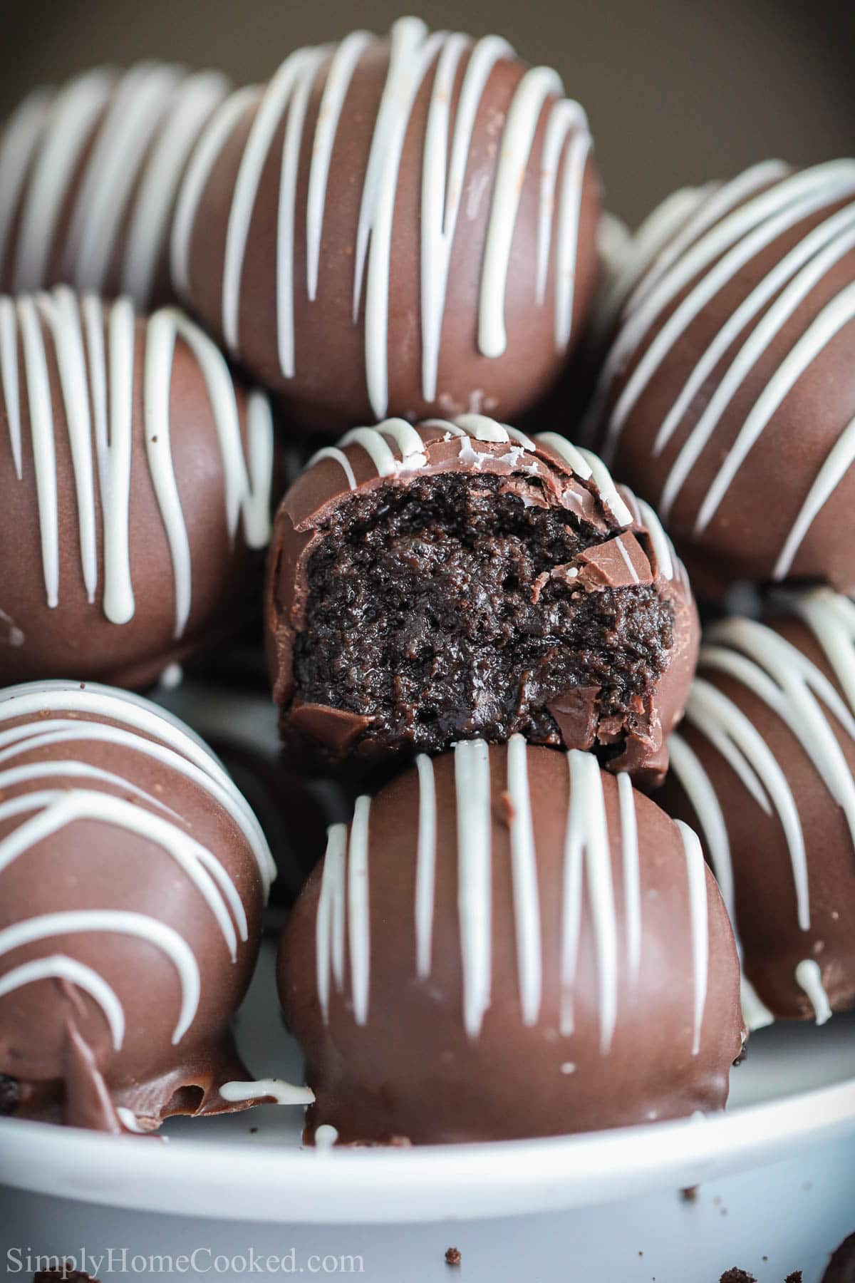 a stack of chocolate Oreo truffles with one bitten into