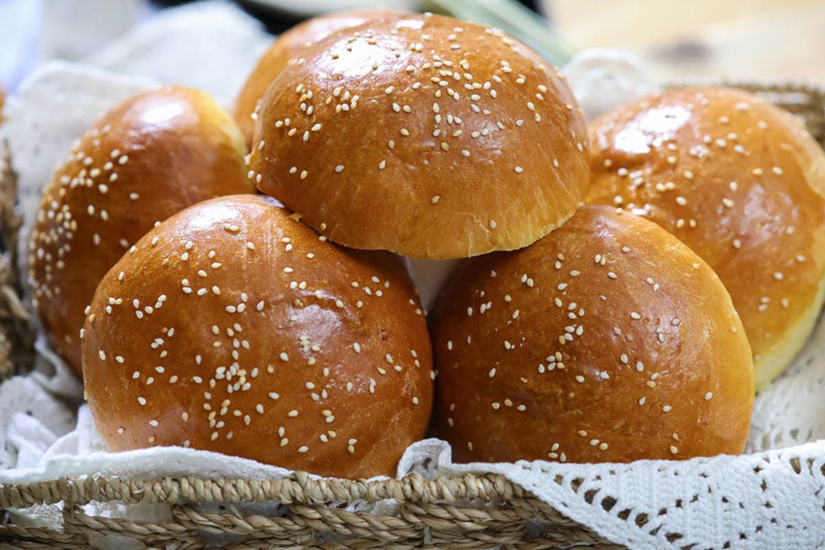 Horizontal image of Brioche Buns stacked in a basket.