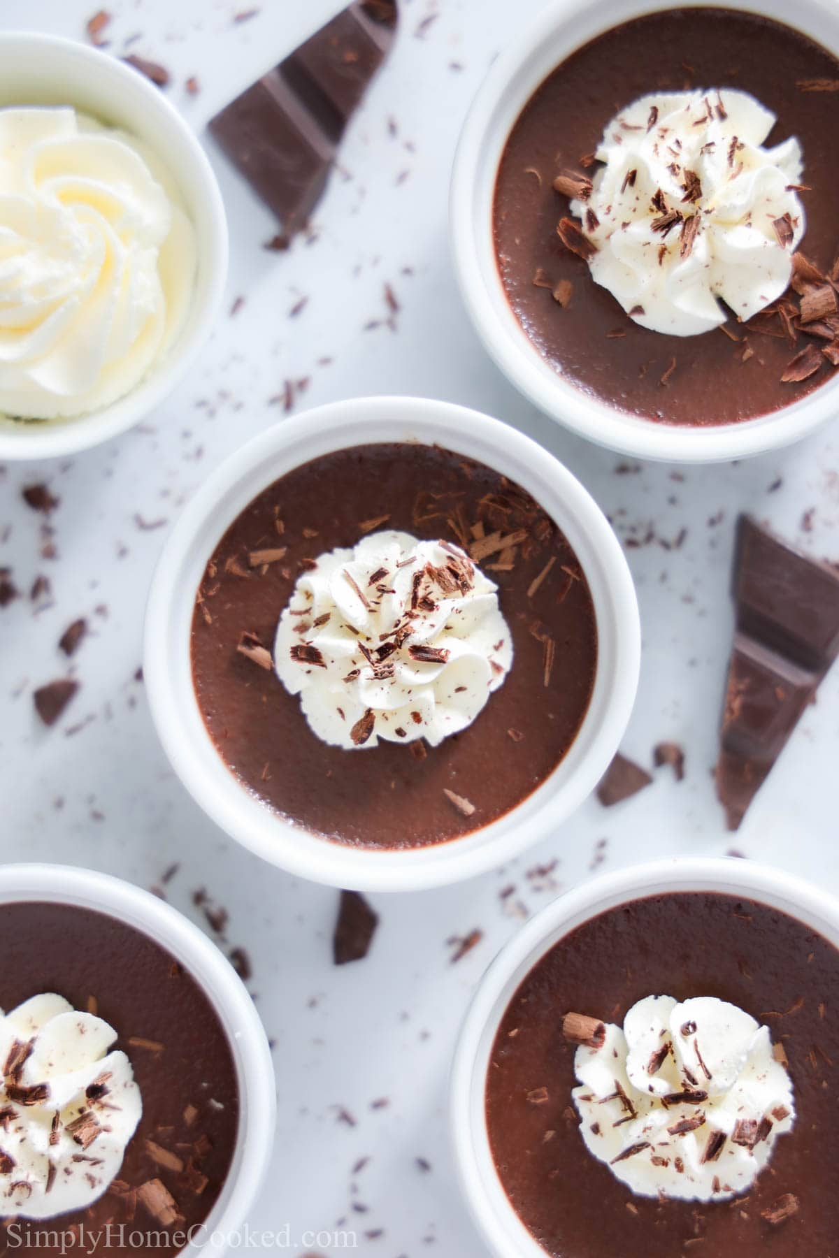 Chocolate Pot De Creme topped with whipped cream and chocolate shavings