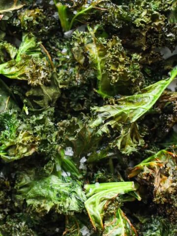 Vertical image of Air Fryer Kale Chips on a white plate