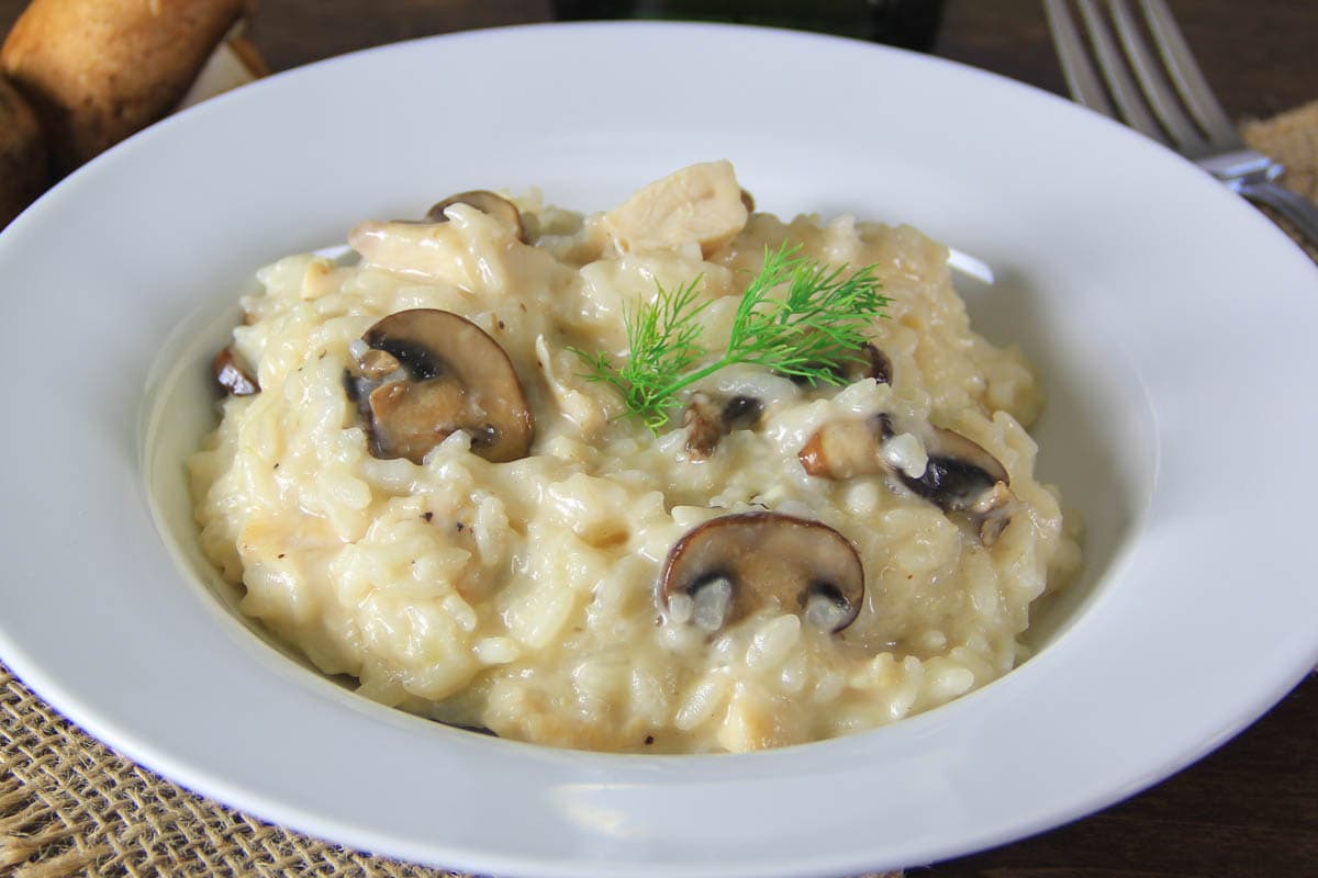 Horizontal image of Mushroom Risotto with Chicken on a white plate