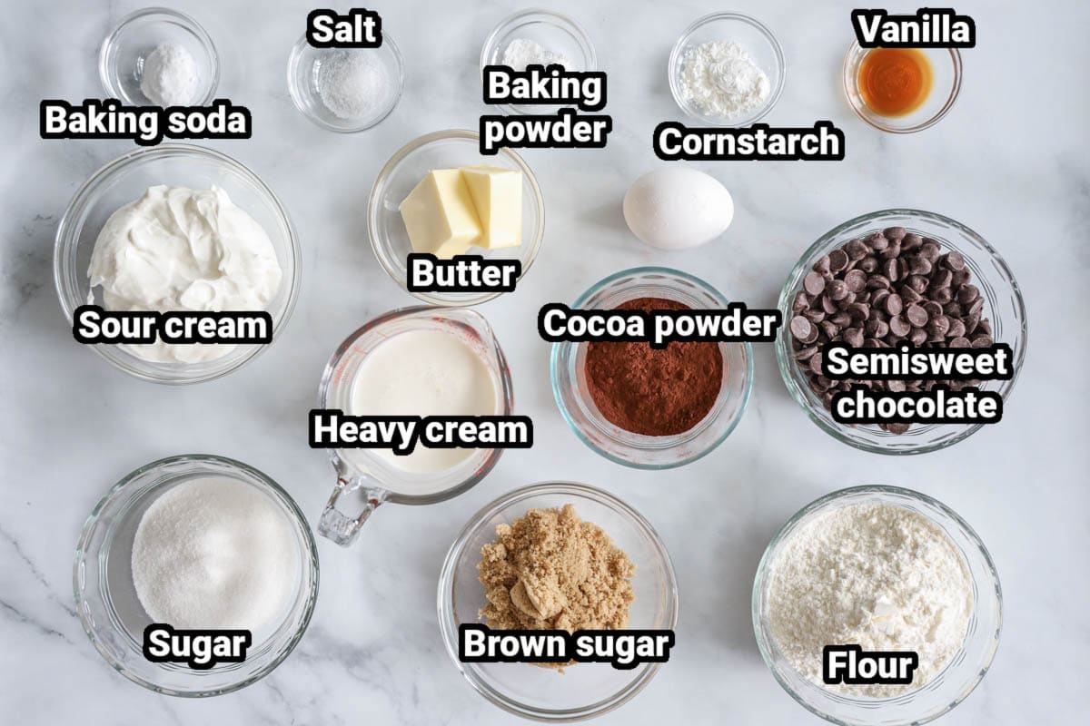 Ingredients for Chocolate Donuts, including sugar, brown sugar, flour, heavy cream, cocoa powder, semisweet chocolate chips, butter, sour cream, egg, cornstarch, vanilla, baking powder and soda, and salt.