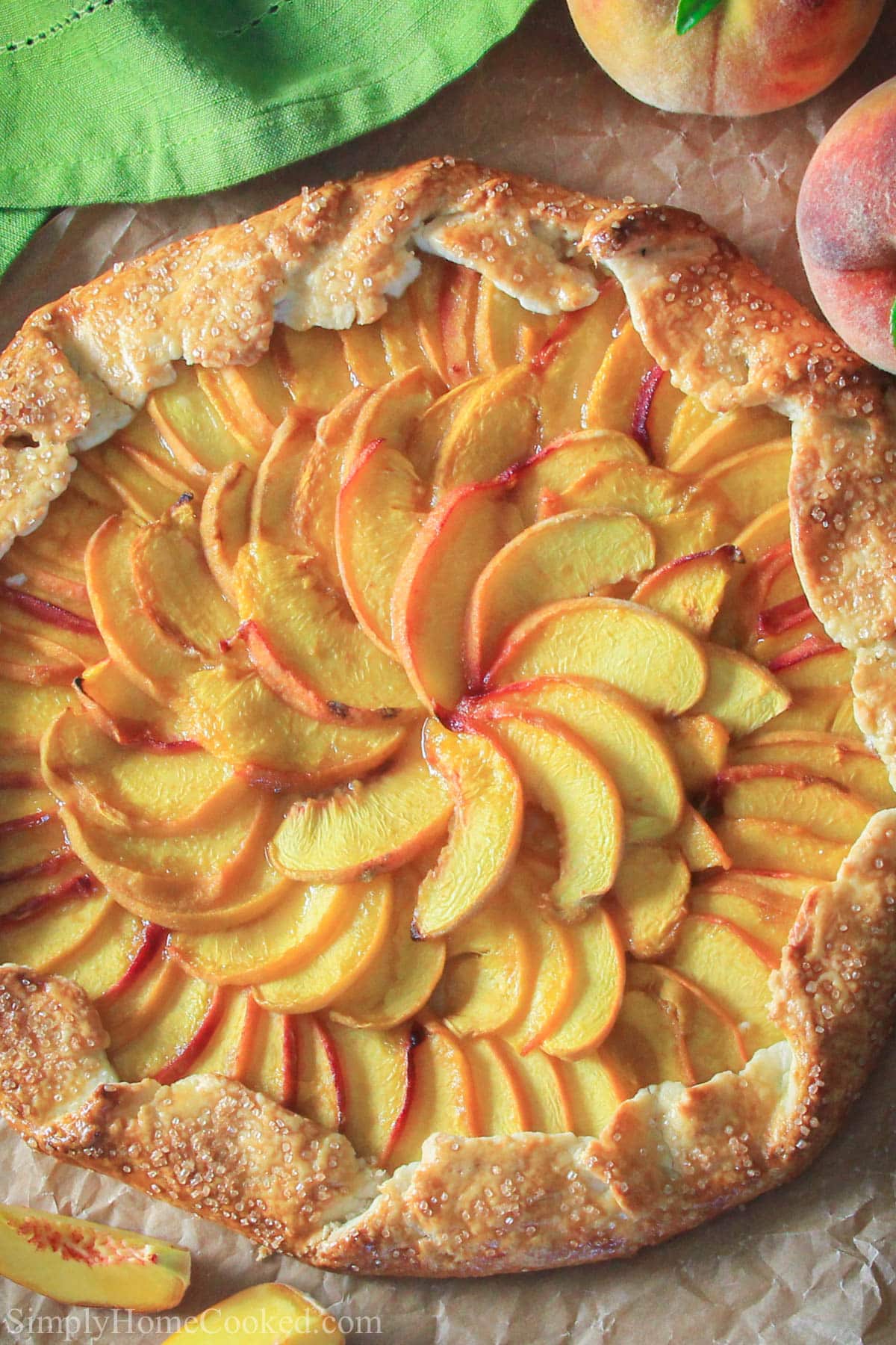 Overhead view of Peach Galette with peaches nearby