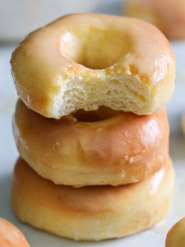 Stack of Glazed Air Fryer Donuts, the top one missing a bite