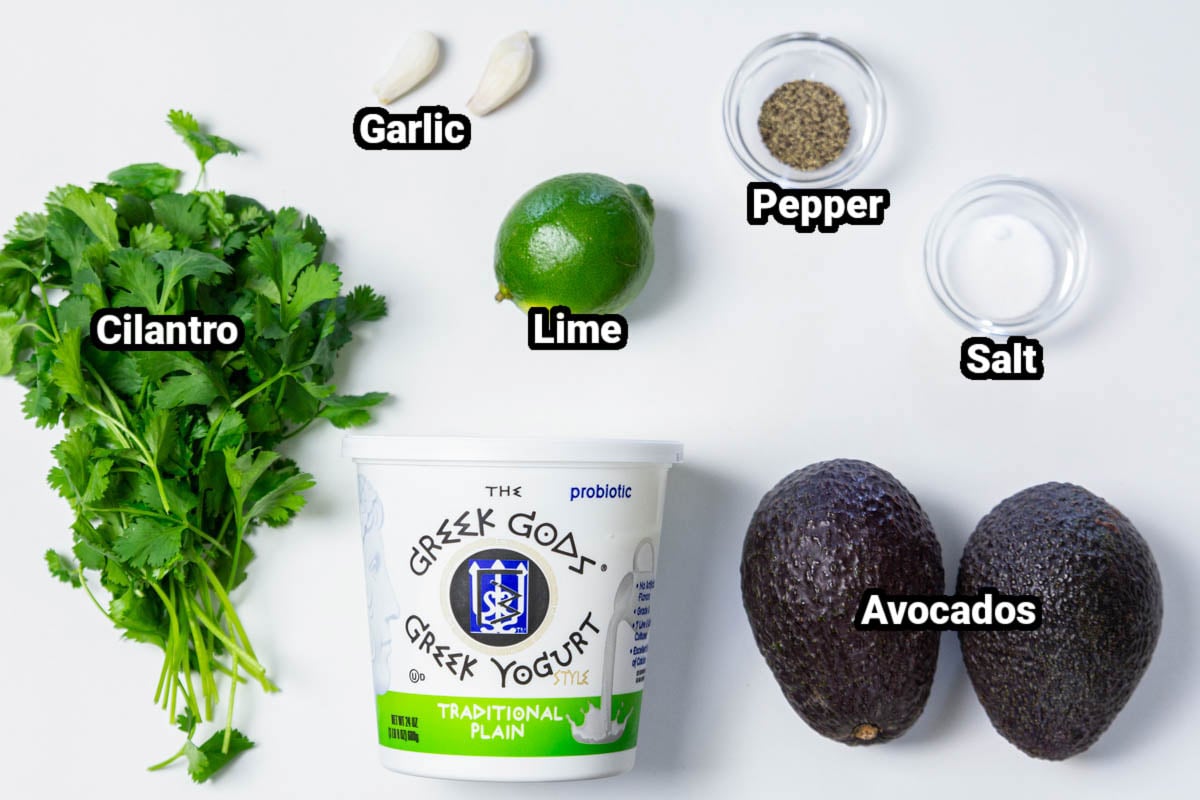 Ingredients in avocado sauce, including plain Greek yogurt, avocados, lime, garlic, salt, pepper, and cilantro.