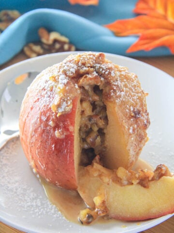 Baked Apple with a slice cut out on a white plate