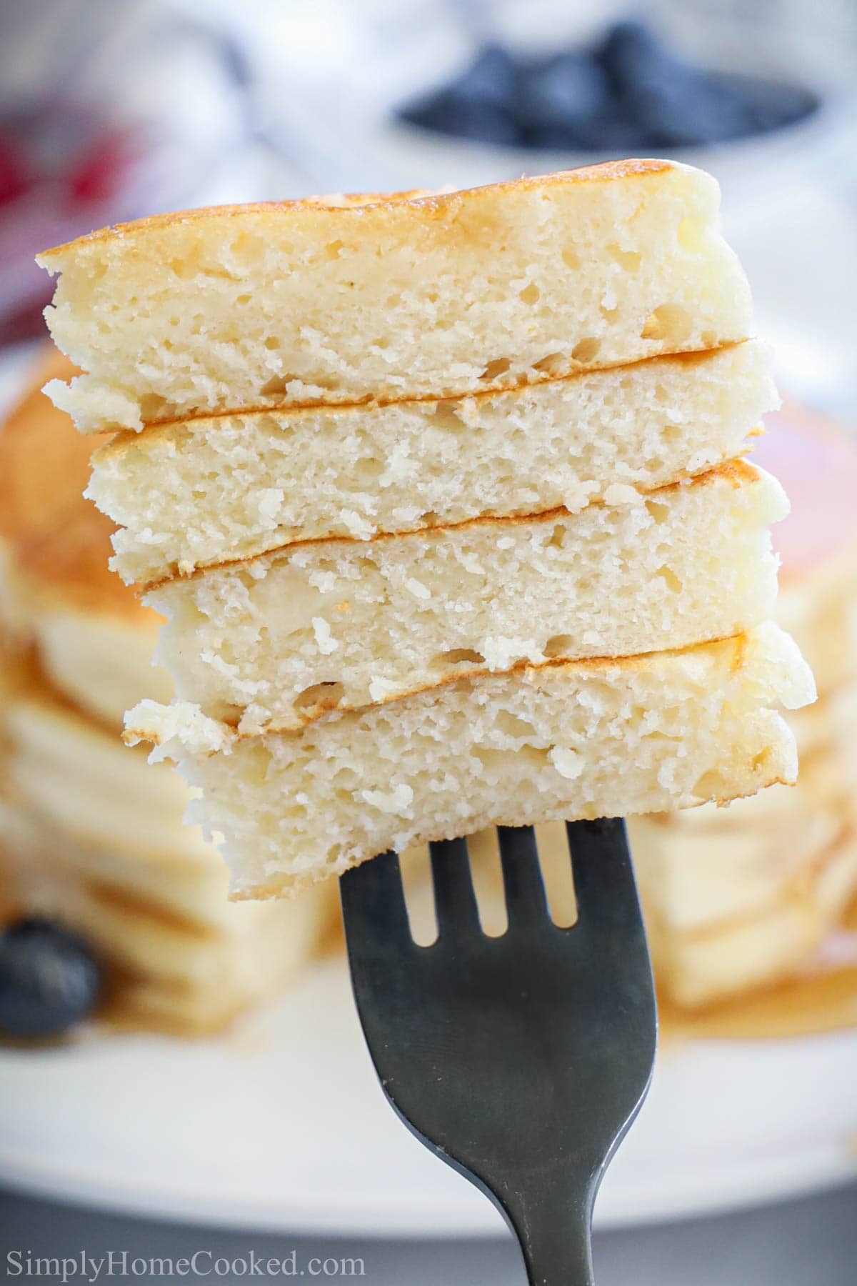 Stack of cut Buttermilk Pancakes speared on a fork