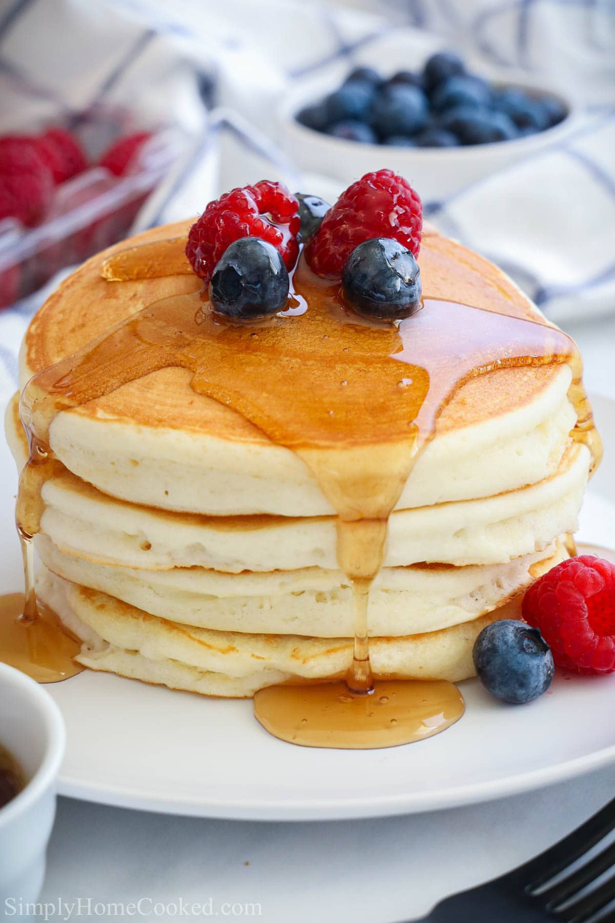 Stack of Buttermilk Pancakes topped with berries and syrup