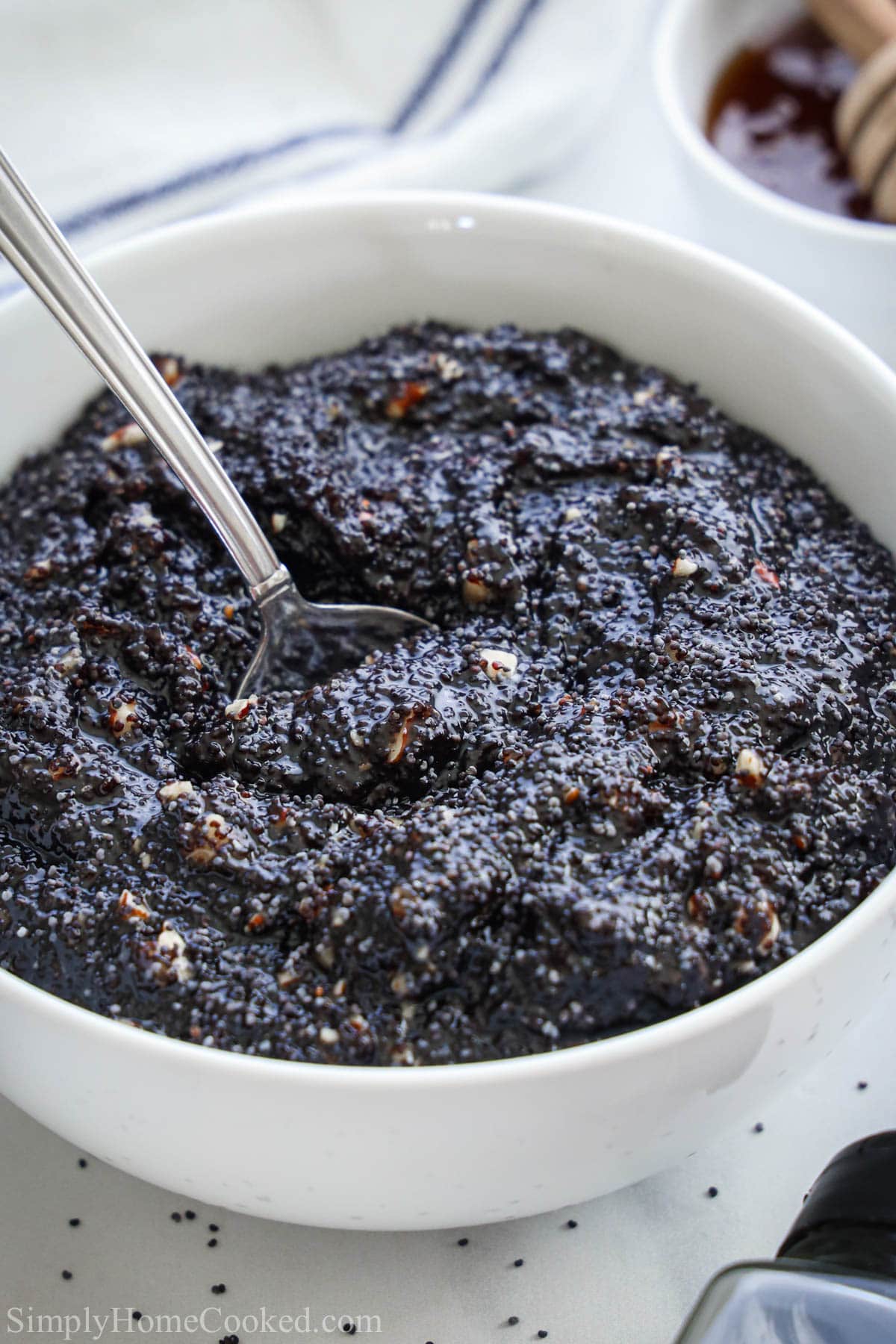 Bowl of Poppy Seed Filling in a white bowl with a spoon.