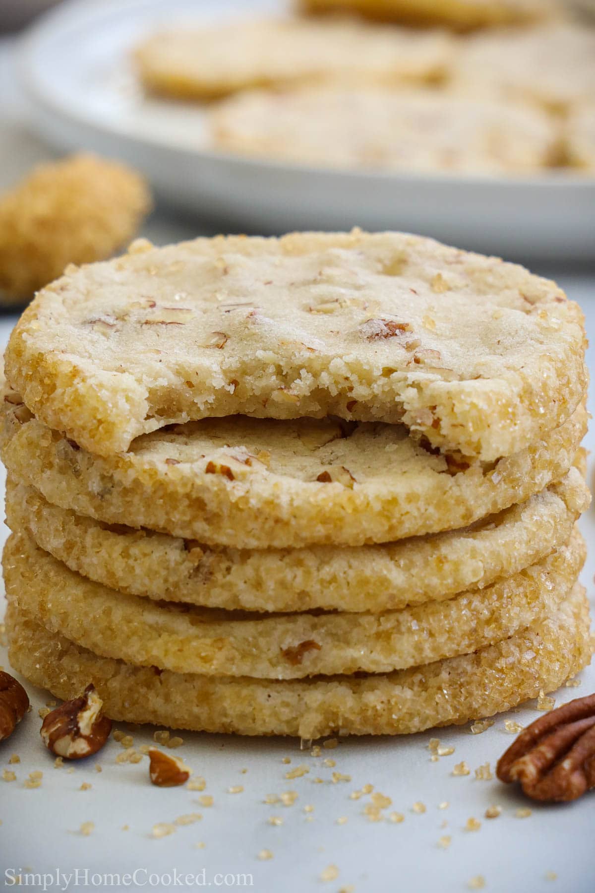 Stack of Pecan Shortbread Cookies, one missing a bite.
