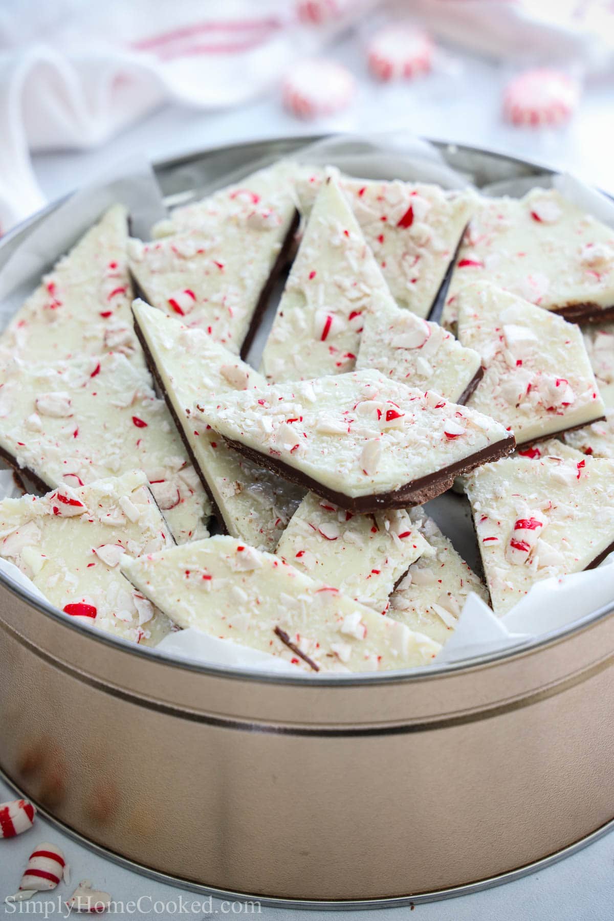Pieces of Peppermint Bark piled in a silver container.