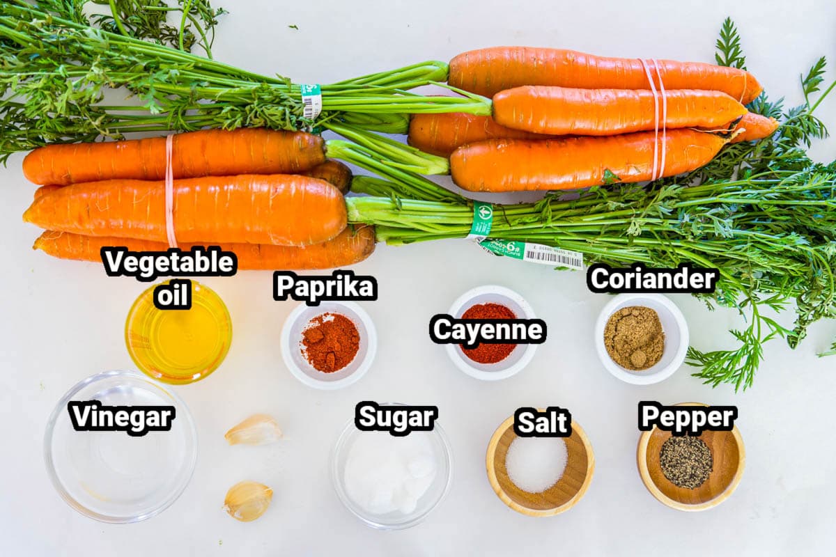 Ingredients for the Shredded Carrot Salad: carrots, oil, vinegar, paprika, cayenne pepper, coriander, sugar, salt, pepper and garlic cloves.