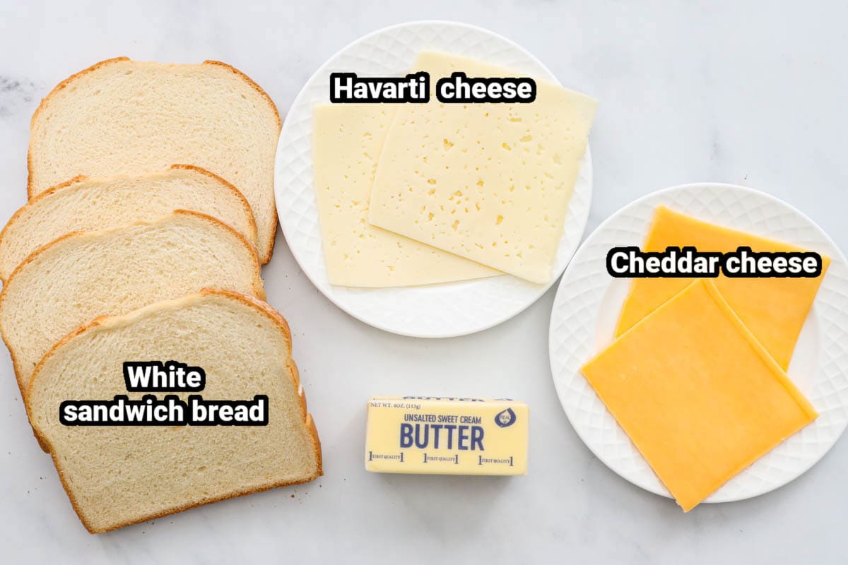 Ingredients for Air Fryer Grilled Cheese: white sandwich bread, havarti and cheddar cheese, and butter.