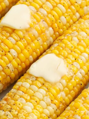 Air Fryer Corn on the Cob covered in pads of melting butter.