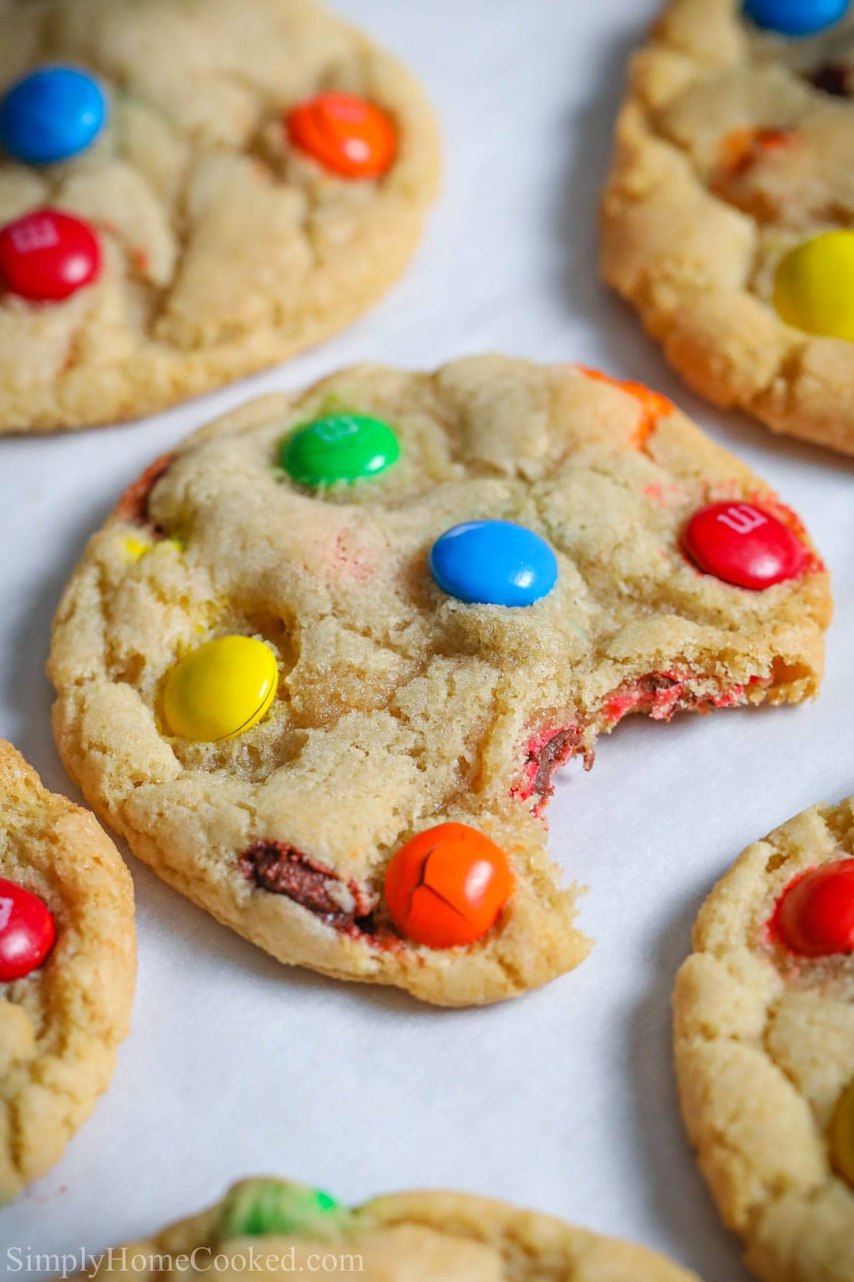 Close up of Chewy M&M Cookies, one missing a bite