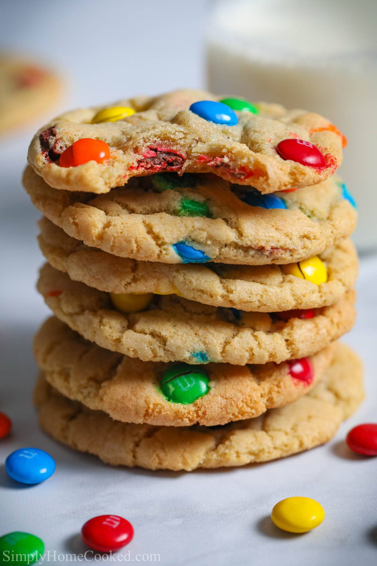 Stack of Chewy M&M Cookies, the top one missing a bite.