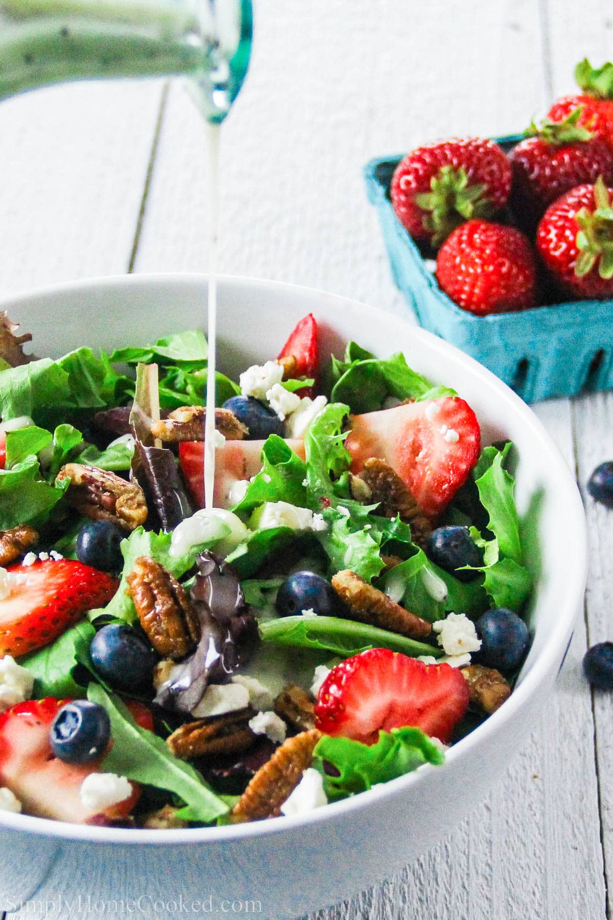 Drizzle the dressing over the strawberry feta spinach salad with berries as a side.