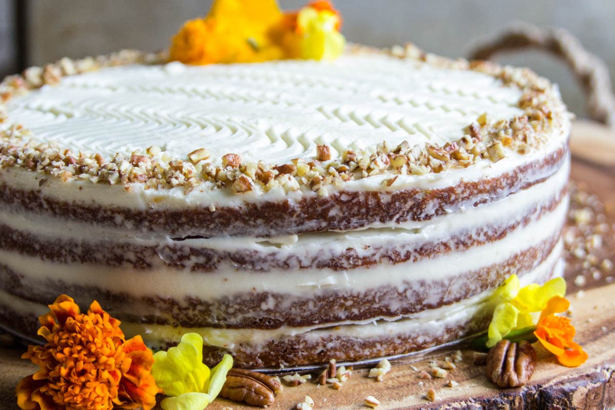 Easy Carrot Cake with cream cheese frosting and a sprinkle of chopped pecans.