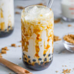 brown sugar boba in a glass cup with a glass straw