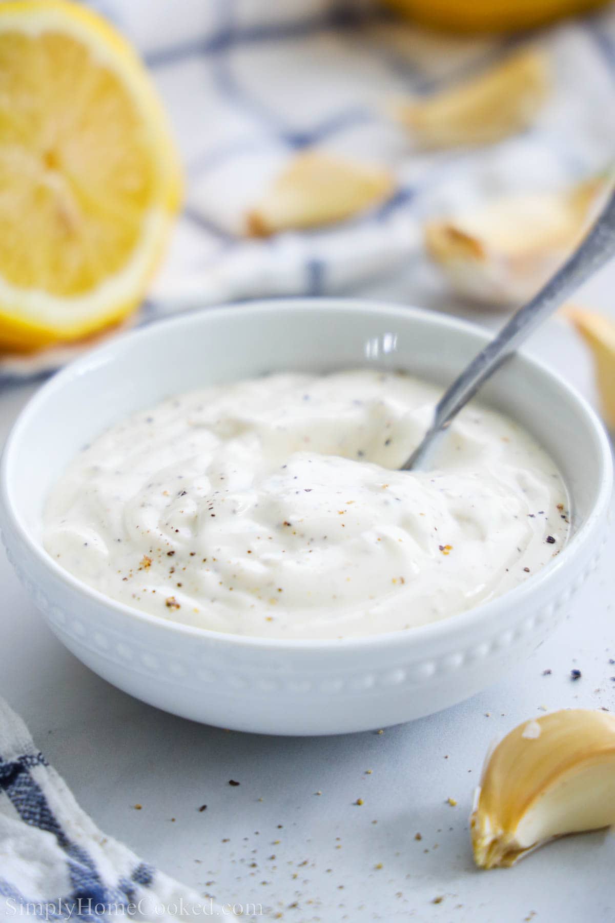 A bowl of Garlic Aioli with a spoon in it.