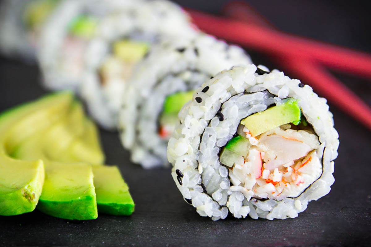 Shrimp Tempura Roll beside cut avocado.