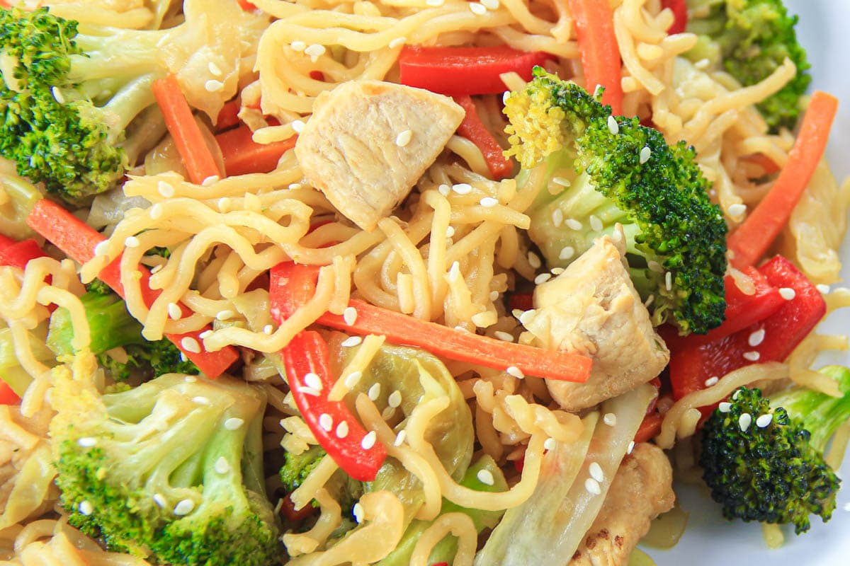 Chicken Chow Mein with bell pepper, broccoli, and sesame seeds.